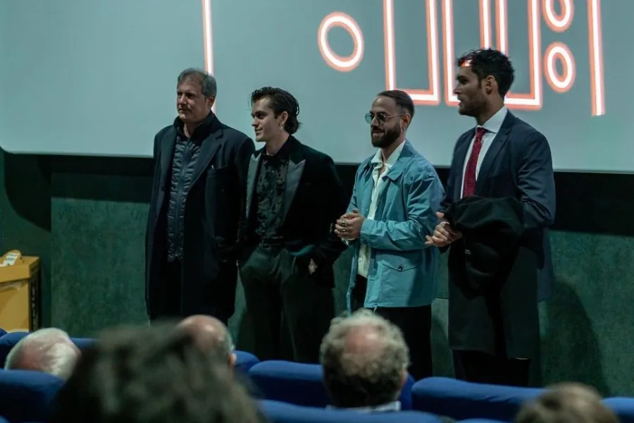 Un gruppo sul palco davanti al pubblico durante una premiazione